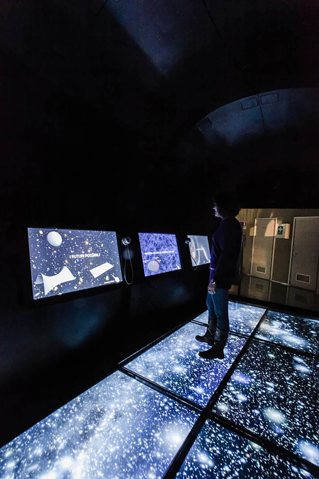 persona davanti exhibit multimediali che rappresentano Astronomia e Spazio, nel percorso rinnovato da ett del planetario di torino