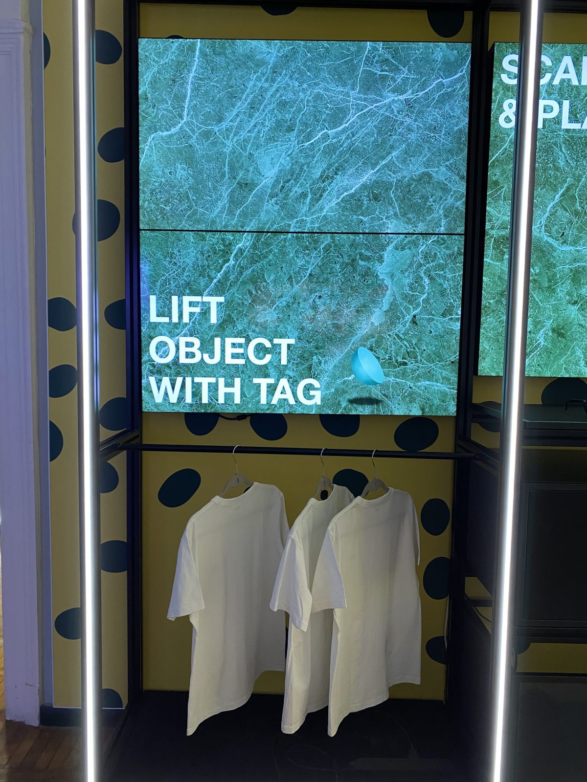 schermo a led con magliette sottostanti, parte della libreria digitale realizzata da Corepixx, azienda del Gruppo ETT, per la sede milanese di Viale Abruzzi