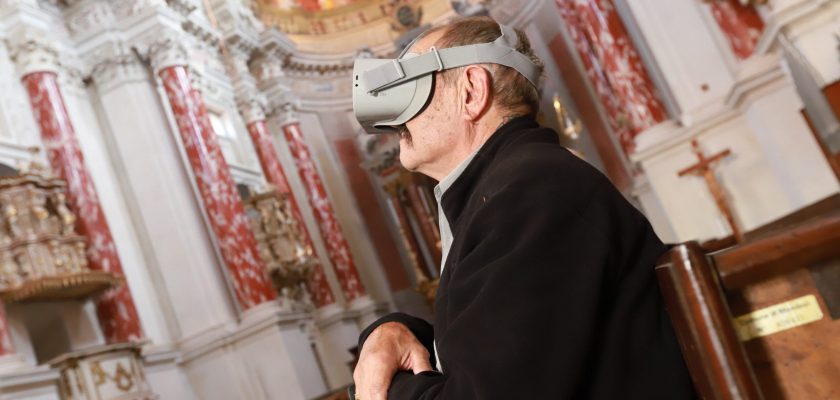 un signore che prova l'esperienza vr all'interno di una chiesa per il progetto infinitum realizzato da ett