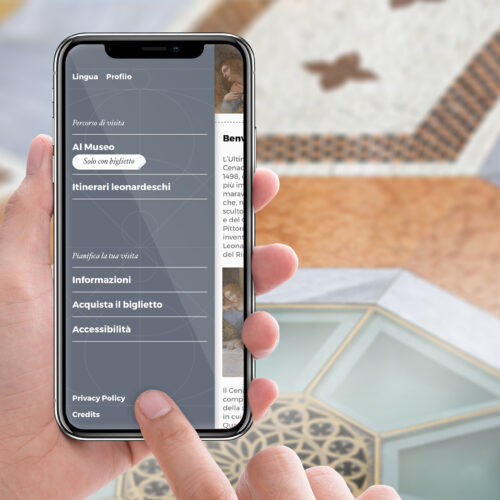 persona con smartphone in mano mentre consulta l'app di visita del cenacolo vinciano sviluppata da ETT